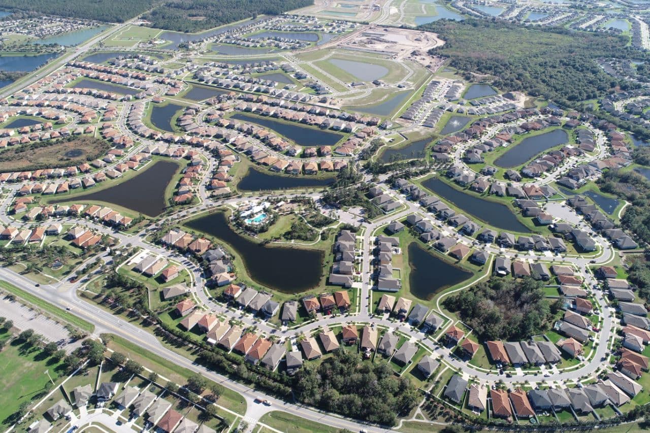 a higher and wider view of Waterleaf housing via drone
